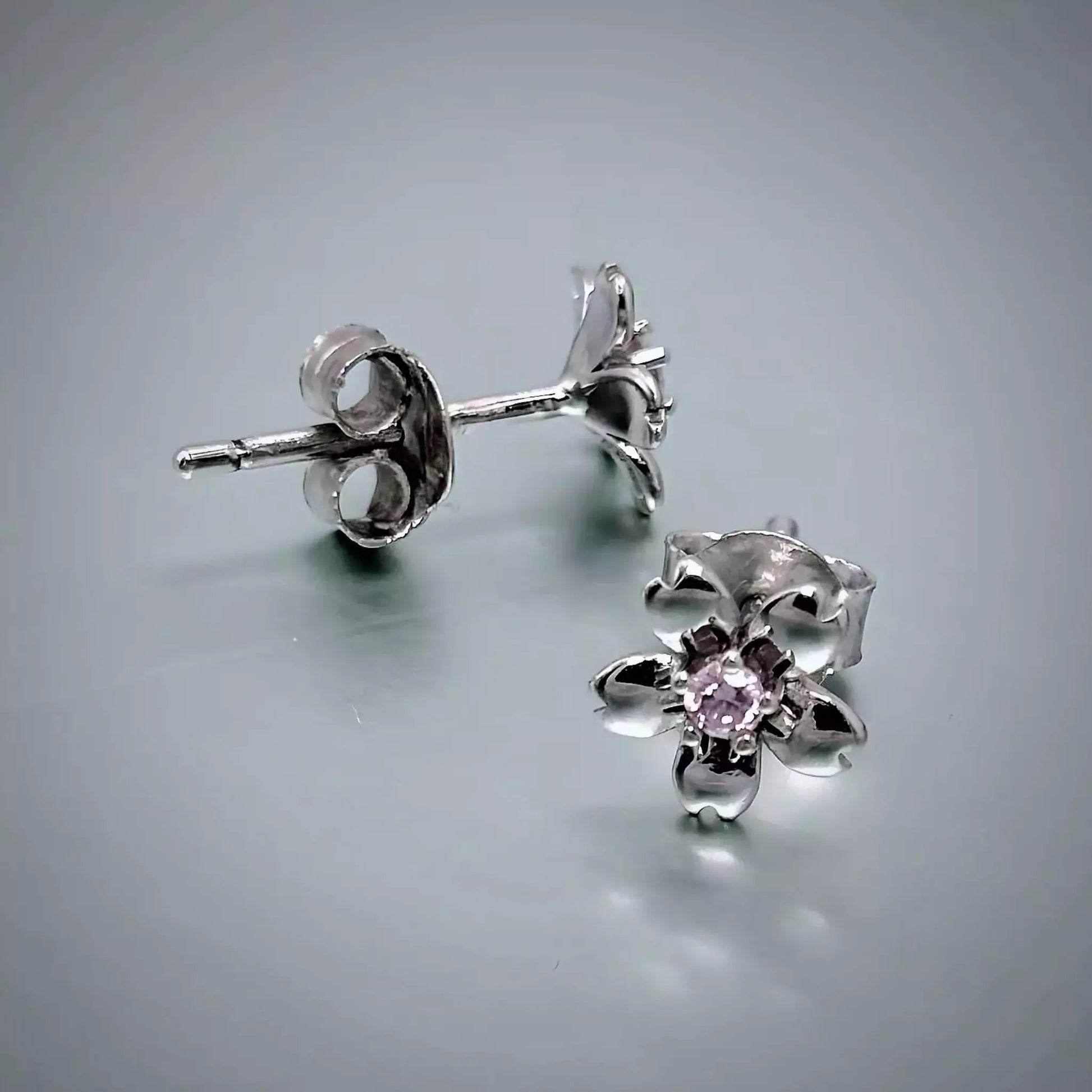 A pair of small Sterling Silver Pink  Flower Studs Earrings , 5 petals, pink cubic zirconia centre stone and butterfly backiings